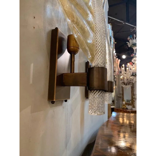 Gorgeous pair of large scale modern Murano glass leaf form sconces. Beautiful flecks of gold on the glass leaves sitting...