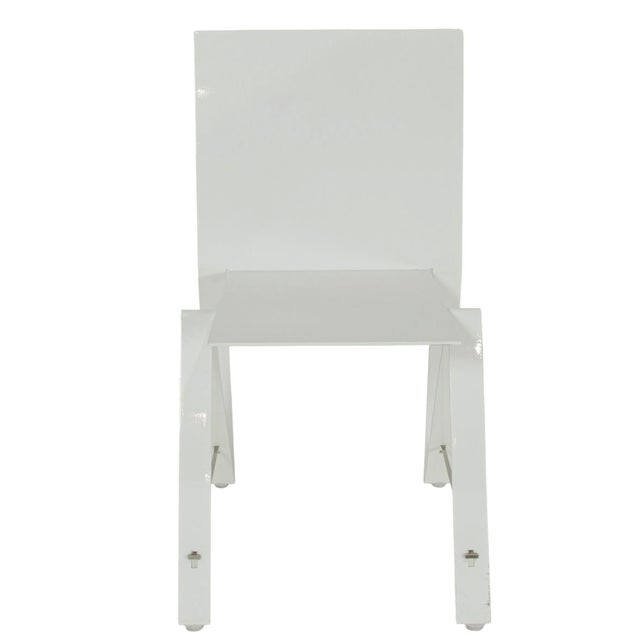 Clean, architectural, and refreshingly understated, this white enameled metal chair embraces the “less is more” philosophy...