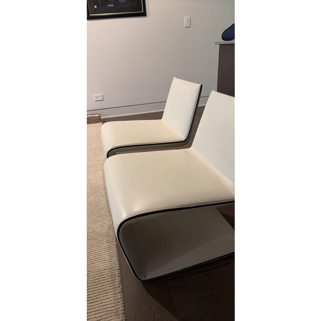 Two White Leather Attributed to Minotti Chairs These are in excellent condition and are a beautiful white/ivory color....