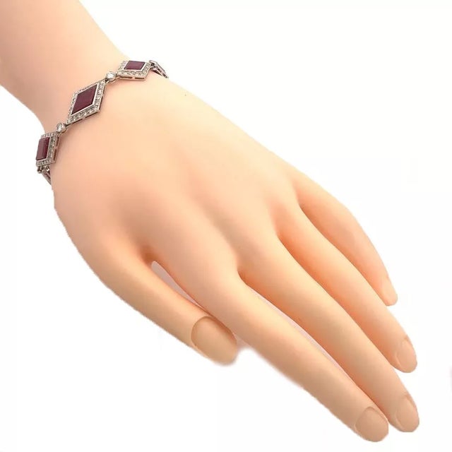 This lovely vintage bracelet is crafted from 14k white gold featuring 8 rhombus shape links with a bezel set rhombus...