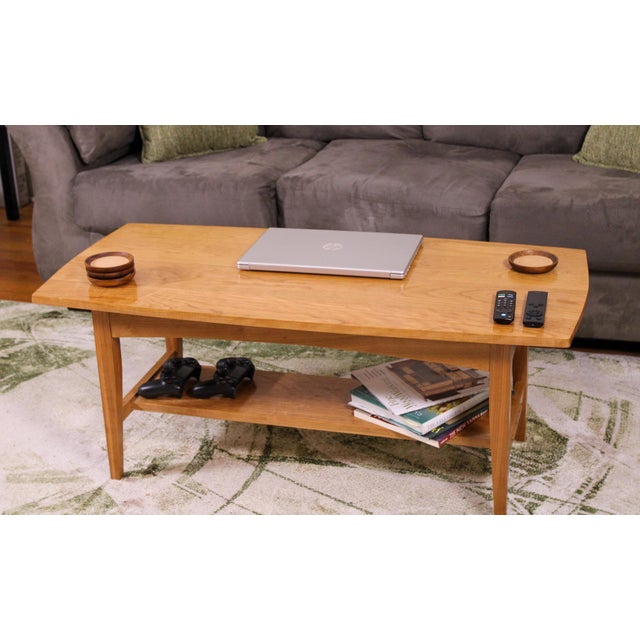 The contemporary cherry coffee table is hand made in our workshop and features a stepped mortise and tenon shelf and an...