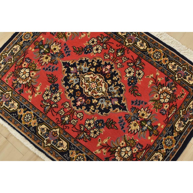 An authentic vintage traditional Qom rug hand-knotted with fine wool and natural dyes. This intricately woven rug features...