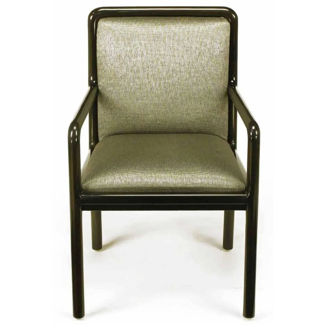 Four Martin Brattrud armed dining chairs. Wood frames are radius and ebonized to a dark chocolate brown gloss. Upholstered...