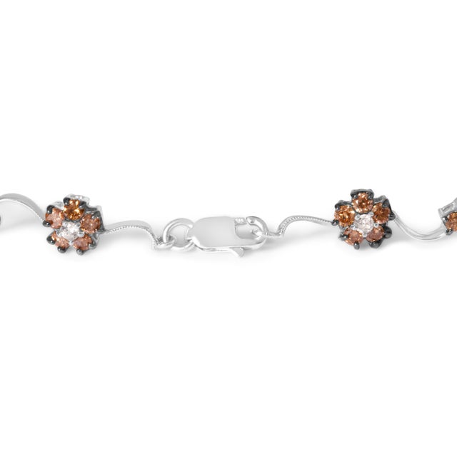 Encapsulate grace around your wrist with this exquisite 10K white gold floral cluster bracelet, a masterpiece of...
