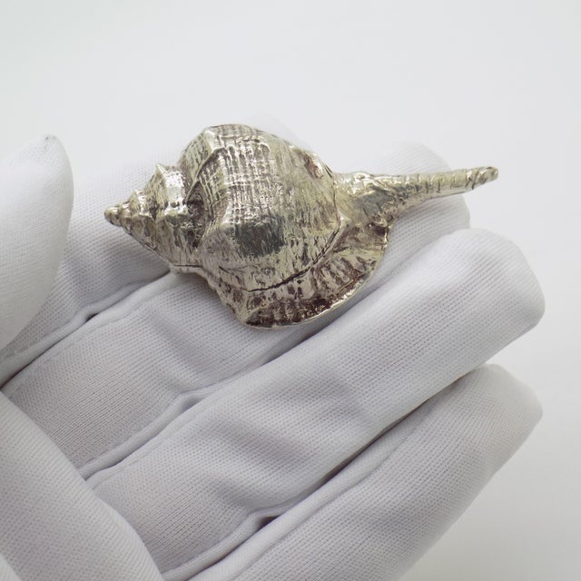 This vintage silver decorative object depicts a sea shell (conchiglia). Handcrafted in florence, tuscany during the 1970s...