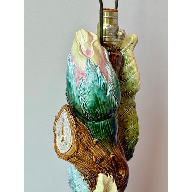 Vintage majolica-style ceramic table lamp featuring large cabbage leaves, a tree trunk, and an oversized flower bud in...