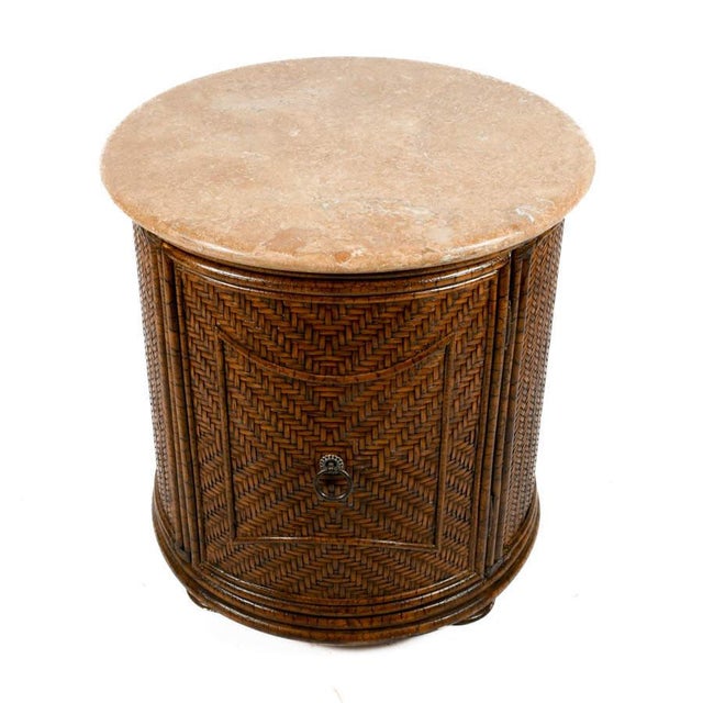 This circular side table offers a refined balance of natural texture and tailored form, blending organic materials with a...