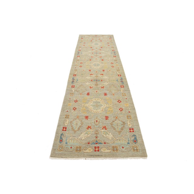 The design showcases a beautiful contemporary Sultanabad runner rug, hand-knotted from wool, featuring a light gray and...