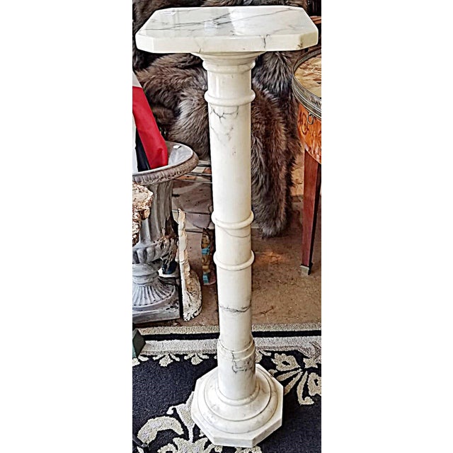 A true classic that fits with modern to palace decor, this 1920th c. carrara marble pedestal with rotating top.