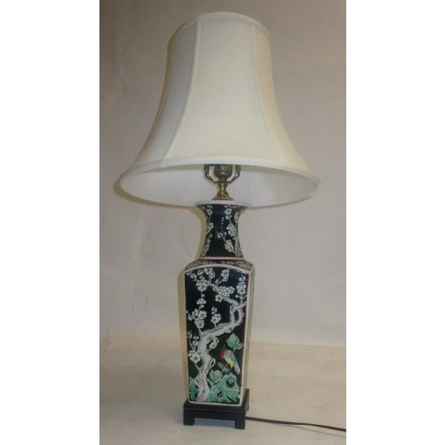 Chinese Export table lamp made from a graceful vase decorated with colorful birds, dogwood branches and fruit on an orange...