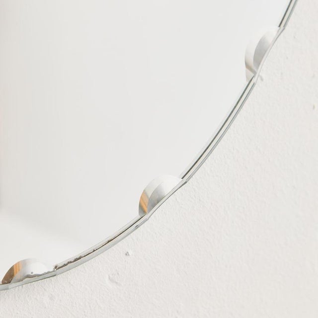 Classic-lined longish mirror from the 1970s. The mirror’s edge has a polished pattern. with some surface scratches and...