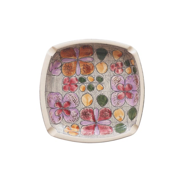 A mid-century ceramic ashtray in the style of Eduardo Vega. A rounded square shaped tray, with cigarette rests in each...
