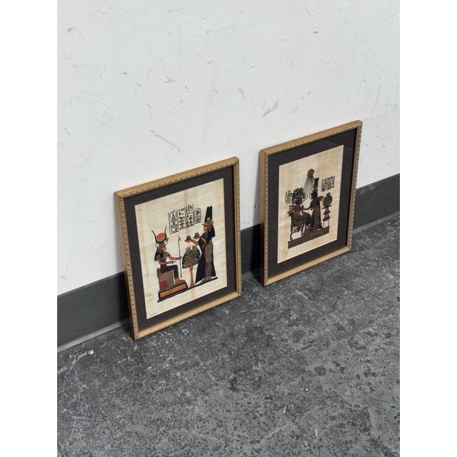 Design Plus Gallery presents a Set of Two Hand Painted Ancient Egyptian Papyrus Artwork. One artwork is of "Nefertari...