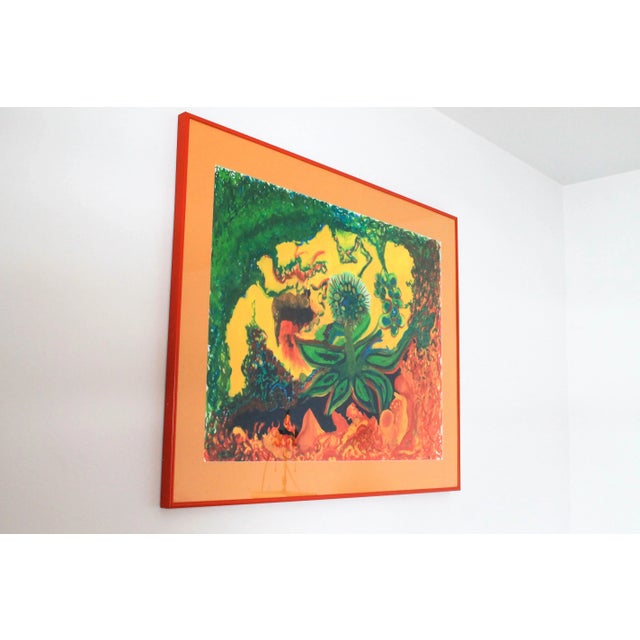 Eye catching vibrantly colored vintage painting of flowering foliage. Professionally framed and matted in an orange frame....