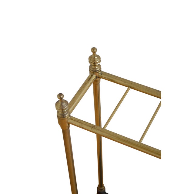 Elegant Victorian umbrella stand in brass with six divisions flanked by decorative finials and cast iron drip tray. This...