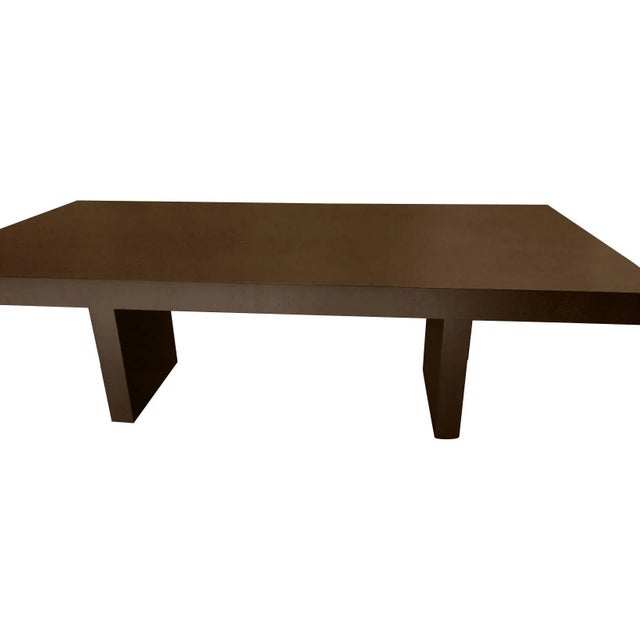 Modern walnut dining table. Table has a solid top, no leaves. The table is done in a dark expresso finish. The skirting is...