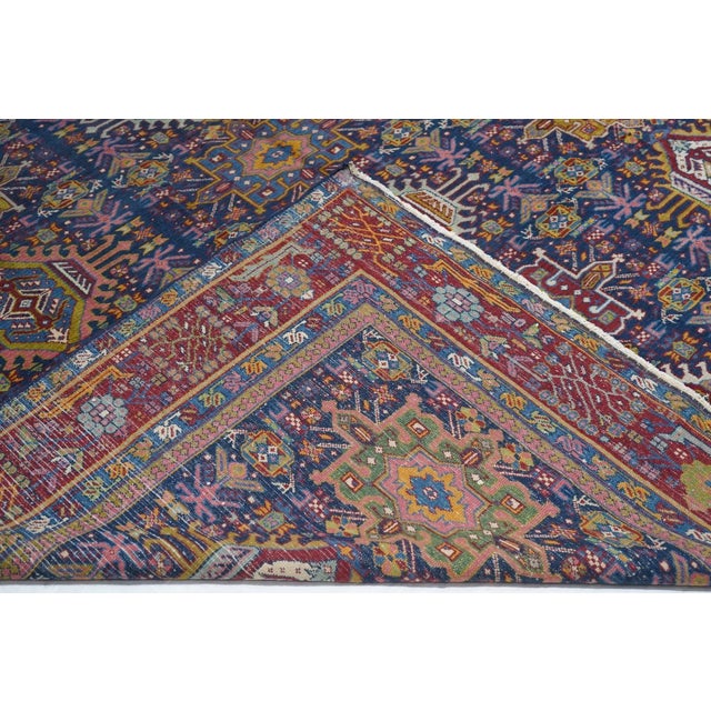 Karaja village in the Heriz District is the source of this royal blue carpet with a three by seven array of characteristic...