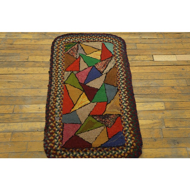 Antique American Hooked rug, size: 1'10" x 3'5". This early 20th-century American hooked rug (circa 1920s) is a vibrant...