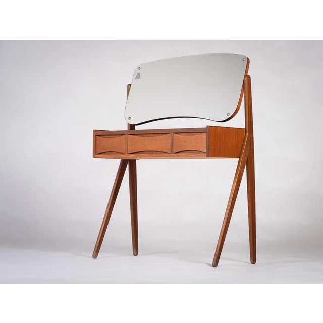 Make-up table in teak, with three drawers and a black glass top produced by Ølholm Møbelfabrik in the 1960s in Denmark. It...