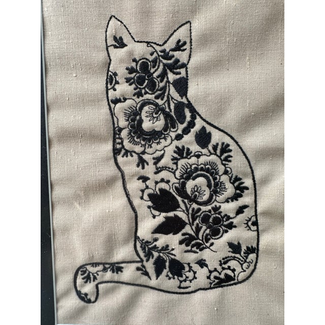 Hand-made framed hand embroidery or crewel-style embroidery on natural linen or linen-blend fabric, depicting a cat filled...