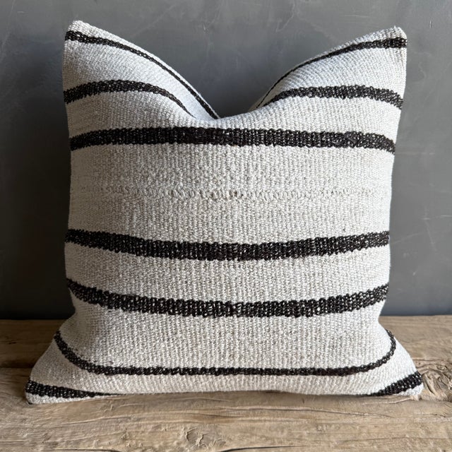 Creamy white hemp rug pillow with stripes. Soft hand, linen blend backing with zipper closure. Spot cleaning is...