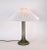The glass base is in undamaged condition. The lamp has been rewired, and includes a new white pleated lampshade. Total...