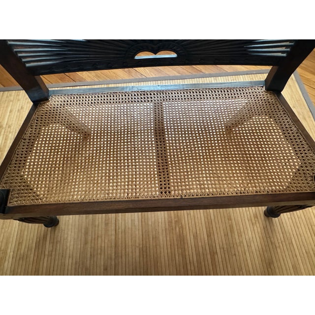 Elevate your space with this sophisticated bench, which features hand-carved woodwork, a slat sunburst carved back with...