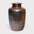 Cloaked inside and out with a warm brown glaze, this antique Chinese pickling pot was originally used for fermenting rice...