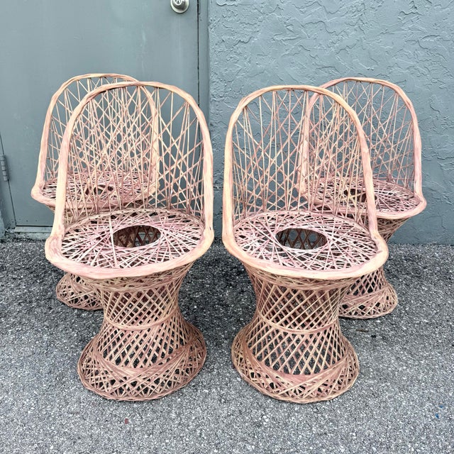 A fabulous set of four vintage mid-century modern chairs featuring sculptural spun fiberglass construction in a soft blush...