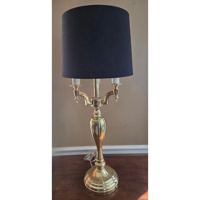 Brass bouillotte style candelabra table lamp. Elegant base supports 3 arms each with a light as well as the center light....