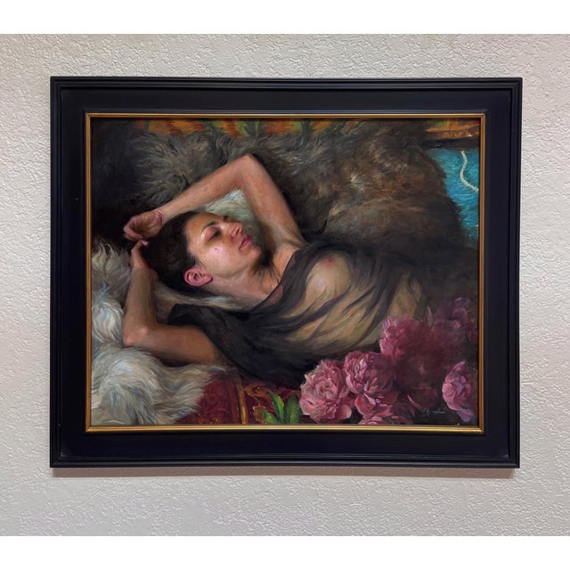 Languishing presents a serene figure reclining against a lush backdrop, enveloped in soft textiles and natural elements....