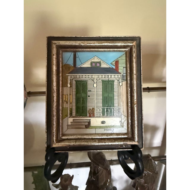 Charming signed miniature painting depicting a classic New Orleans shotgun house with iconic green shutters, decorative...