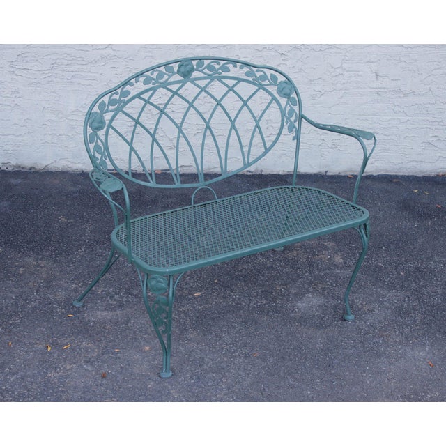 High Quality Wrought Iron Garden Bench Featuring A Decorative Backrest With Interlaced Scrollwork And Cast Rose Motifs...
