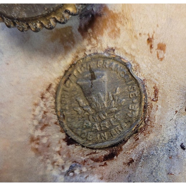 A rare pair of French gilt bronze and marble mantel or bureau urns. Each features marble wraped with gilt bronze mounts...