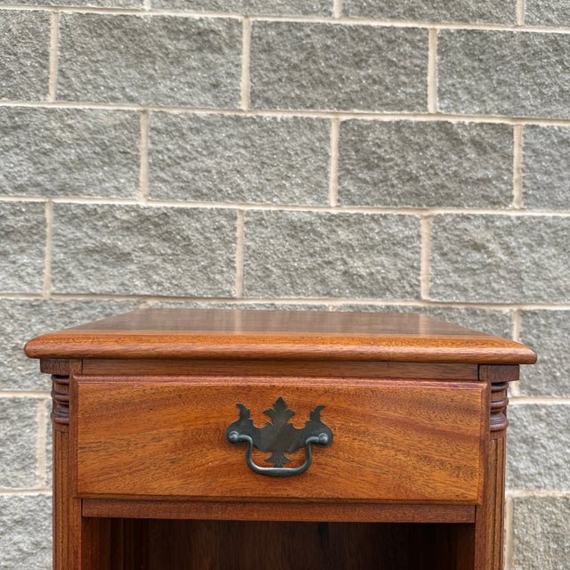 A vintage Kling Furniture Chippendale solid mahogany nightstand having one dovetailed drawer with a brass bail pull over...