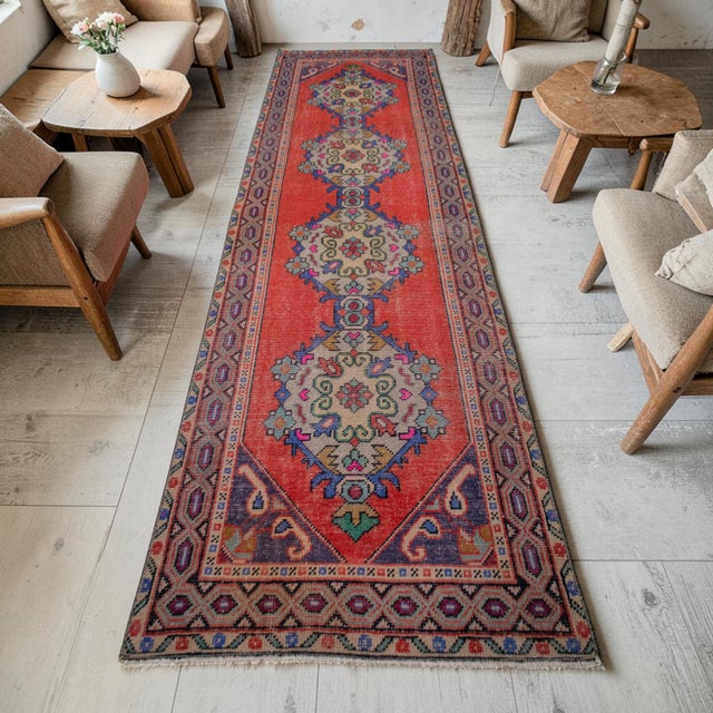 Woven on a traditional family loom in Central Anatolia during the 1960s, this remarkable vintage runner rug presents an...