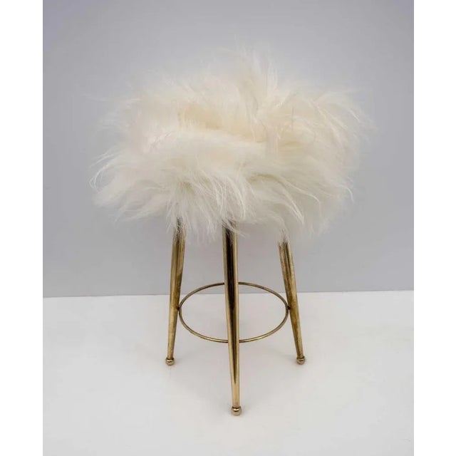 Small brass stool designed by Gio Ponti in the 1950s. Polished and covered with goat skin. This piece is attributed to the...