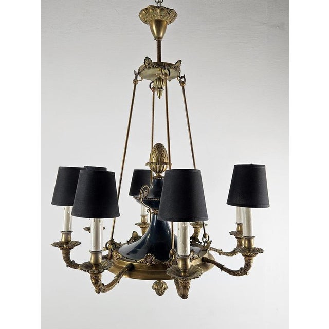 Striking Italian Empire-style chandelier executed in black lacquered metal with gilt bronze and brass details, dating from...
