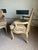 A charming pair of French Louis XV style bergère chairs featuring carved wood frames with a softly distressed finish,...