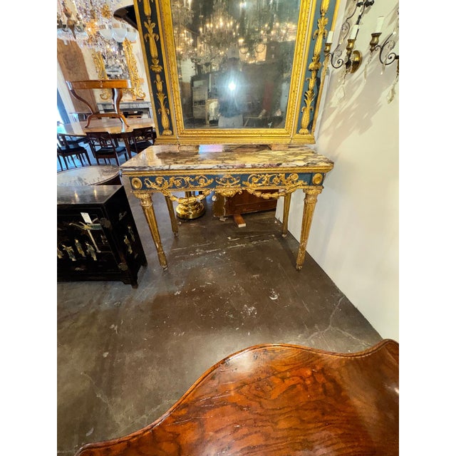 The 18th c. Italian Neoclassical Parcel Gilt Console is a luxurious and elegant piece of furniture that exudes...