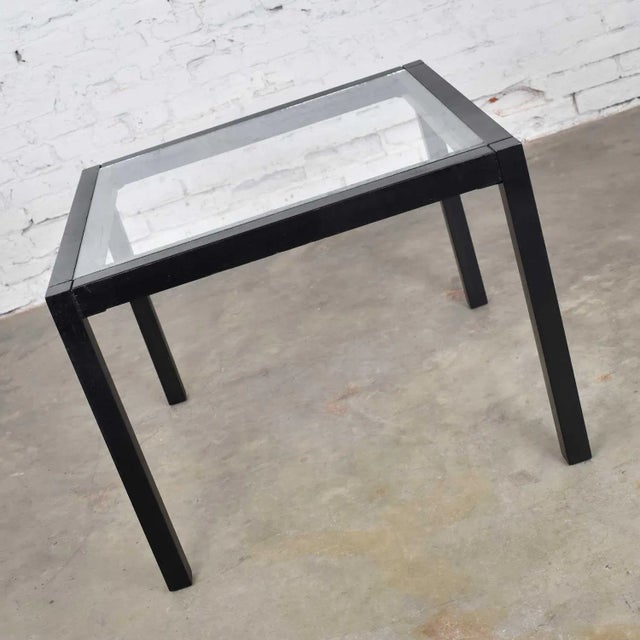 Handsome vintage modern blackened oak square Parsons side table with glass top. It is in beautiful vintage condition. The...