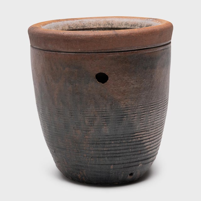 This large ceramic pot is an antique Chinese fish pond from the late 18th century, sourced directly from a family...