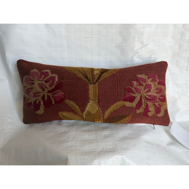 An elegant antique pillow fashioned from a genuine 18th century French Aubusson tapestry fragment, showcasing a...