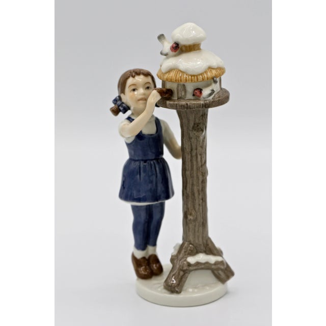 Figurine # 757 of a young girl feeding birds in a bird house. Very attractive and in excellent condition.