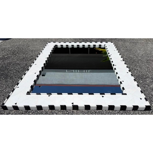 Stunning vintage wall mirror with a distinctive black and white marble frame. Cathcing high-contrast geometric design....