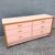 A striking blend of softness and structure, this postmodern dresser features a blush pink high-gloss laminate finish...