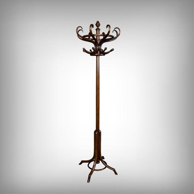 This bentwood coat rack, crafted in the early 20th century, embodies all the charm and technical mastery of furniture from...