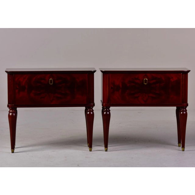 Circa 1960s pair of Italian bedside chests in a dark tiger wood with pull down compartment drawer fronts, tapered legs...