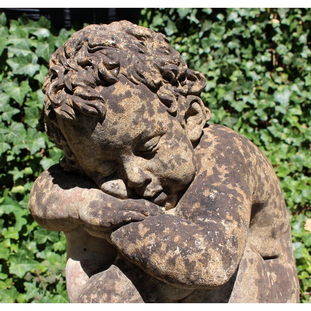 Cast stone garden figure of a sleeping boy on a ball, English, mid-20th century. Charming and unusual. Great patina. Well...