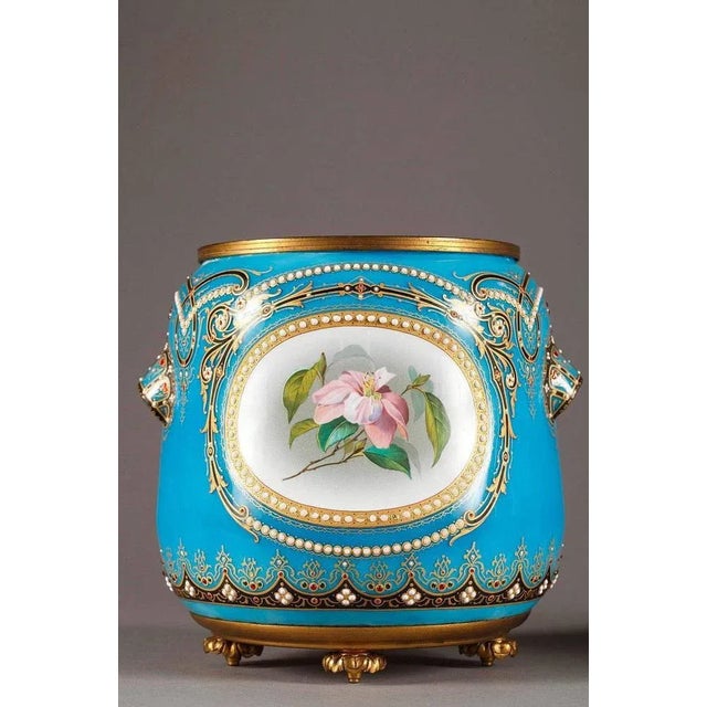 Late 19th century pair of jardinières in blue enamel from bresse. Multicolored medallions depicting delicate flowers are...